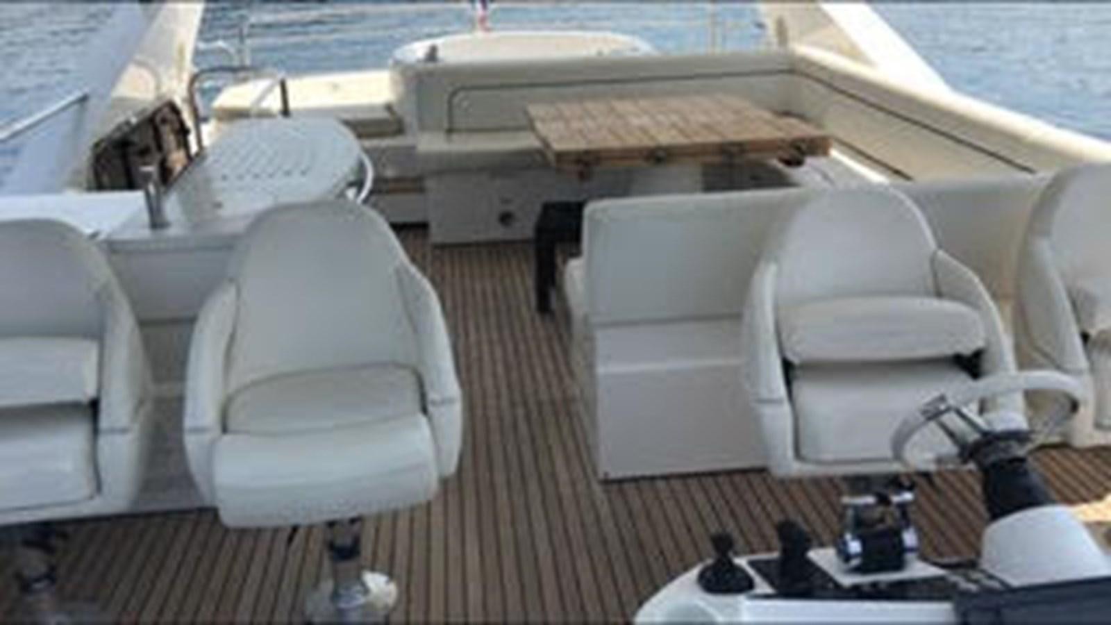 a boat with a table and chairs aboard 81935-3588701 Yacht for Sale