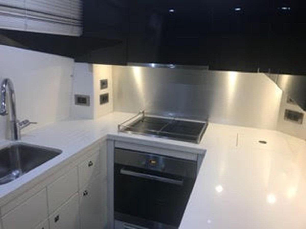 a kitchen with a stove and sink aboard 81935-3588701 Yacht for Sale