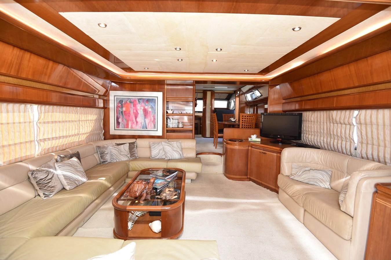 a living room with a couch and a tv aboard SANTA MARIA III Yacht for Sale