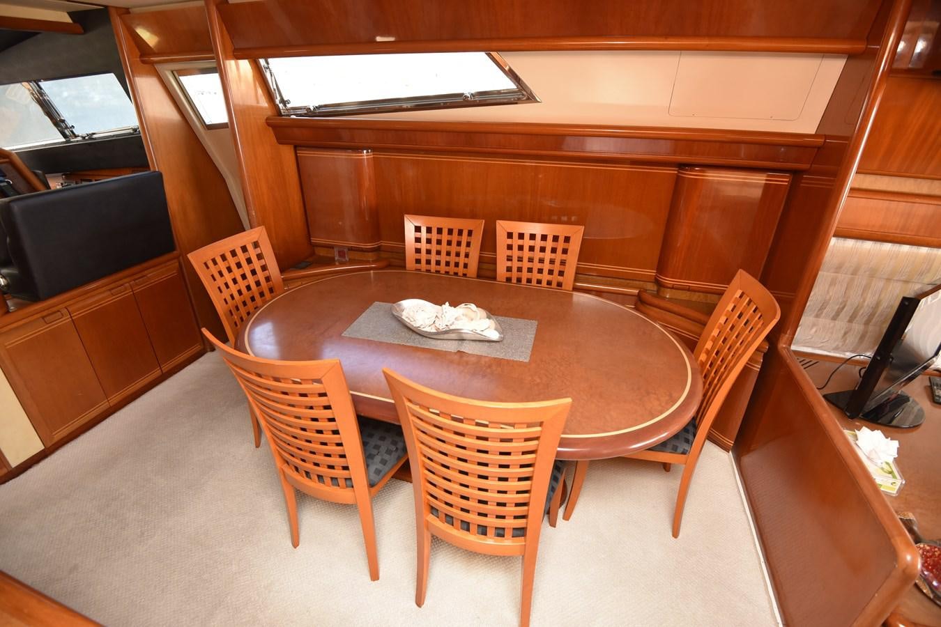 a table with chairs around it aboard SANTA MARIA III Yacht for Sale