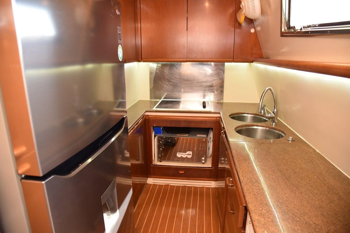 a kitchen with a stainless steel oven aboard SANTA MARIA III Yacht for Sale