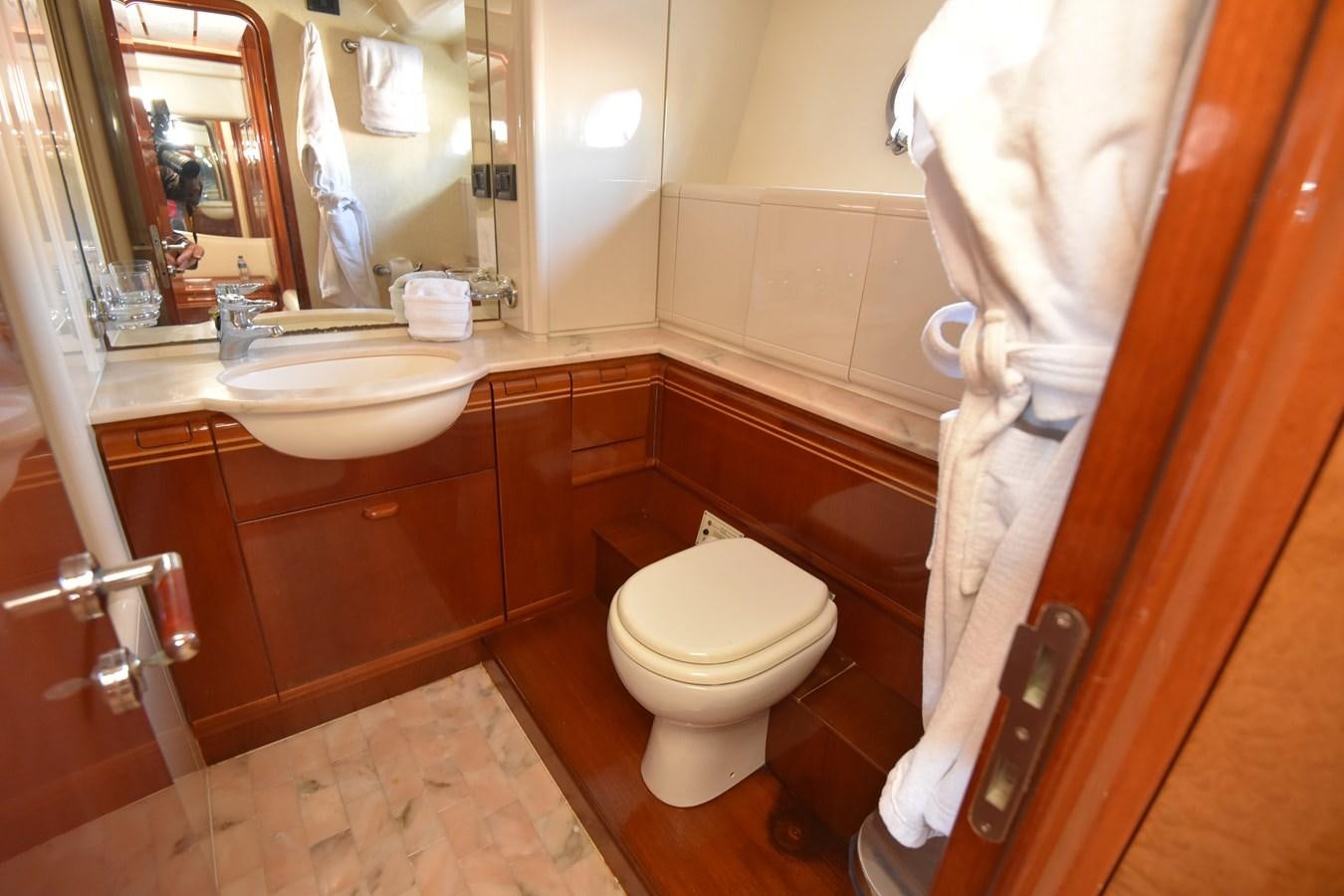 a bathroom with a toilet and a sink aboard SANTA MARIA III Yacht for Sale