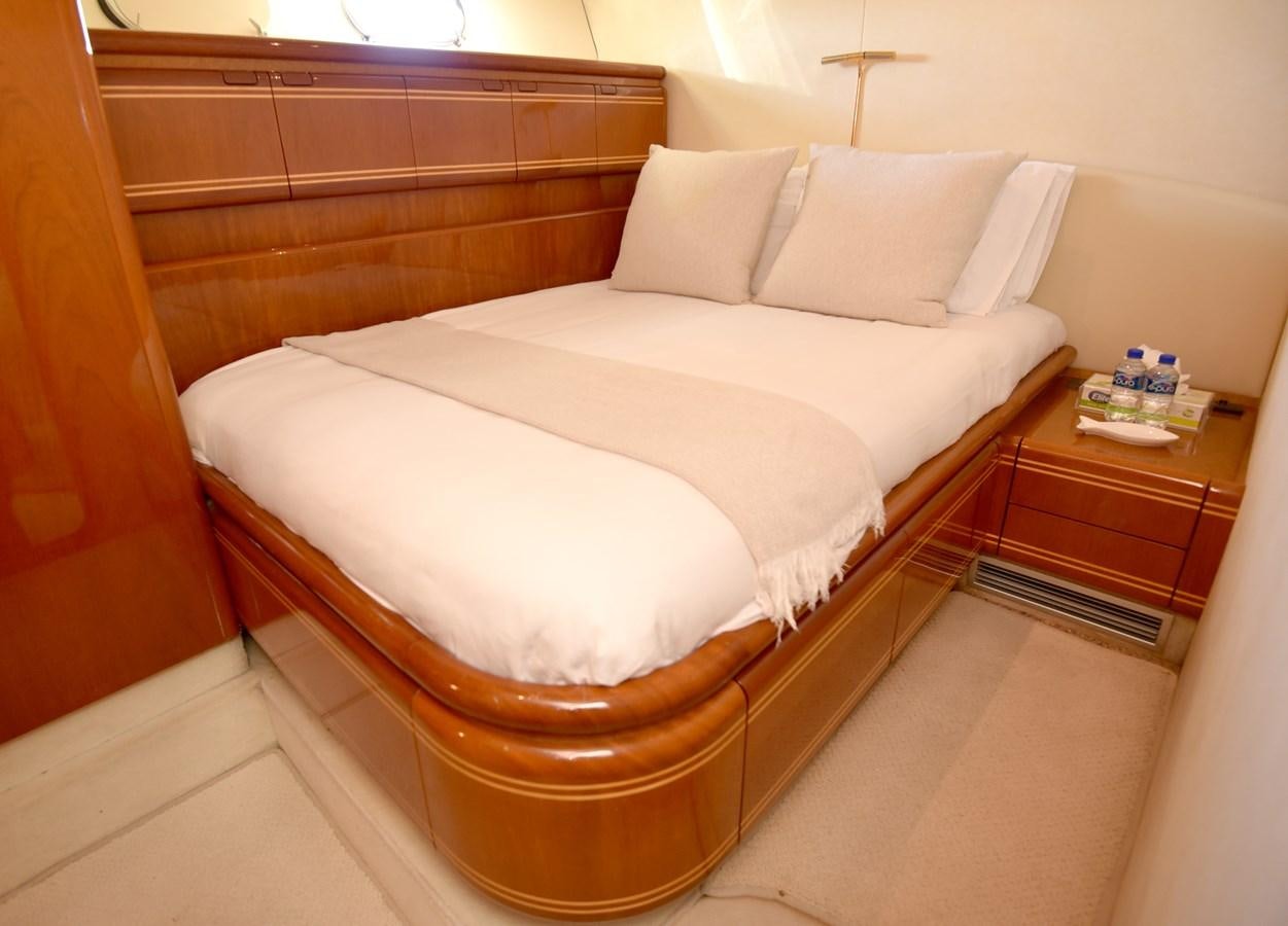 a bed with a white comforter aboard SANTA MARIA III Yacht for Sale