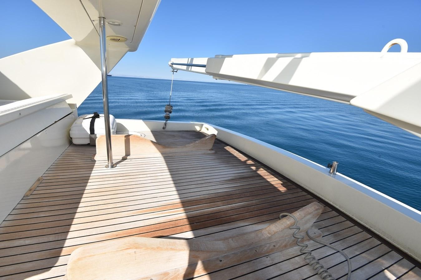 a wooden deck with a white boat aboard SANTA MARIA III Yacht for Sale