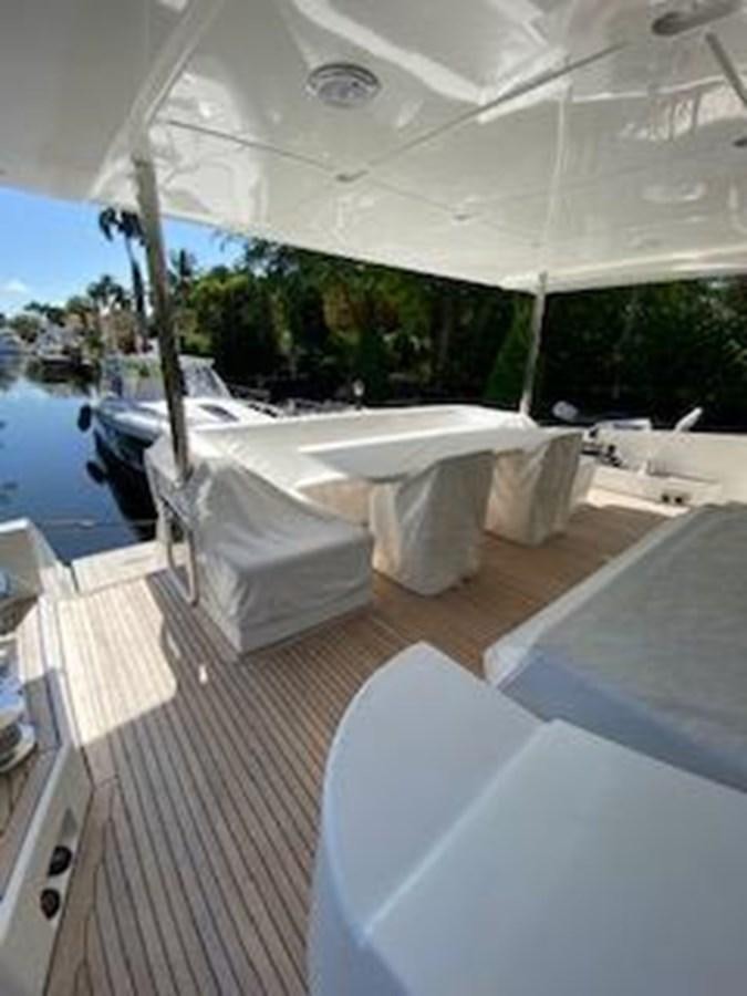 a room with a pool table and chairs aboard FORTUNA Yacht for Sale