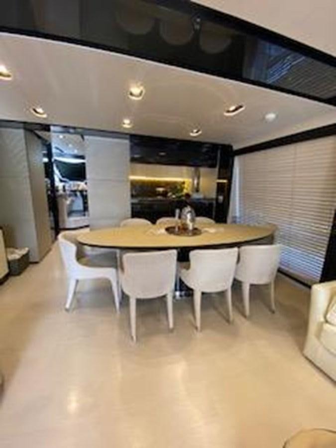 a table and chairs in a room aboard FORTUNA Yacht for Sale