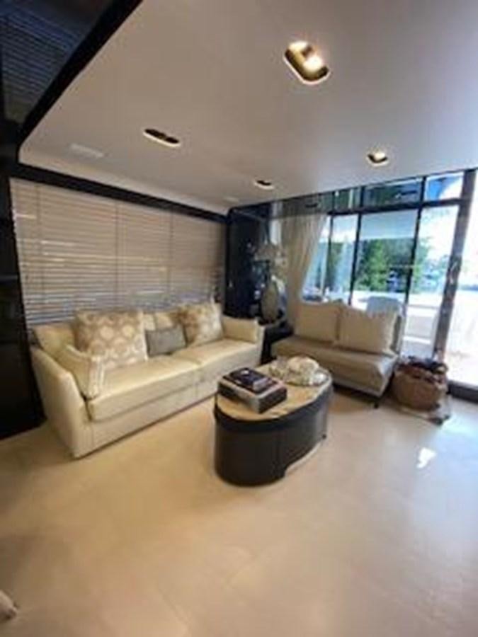 a living room with a couch and a coffee table aboard FORTUNA Yacht for Sale
