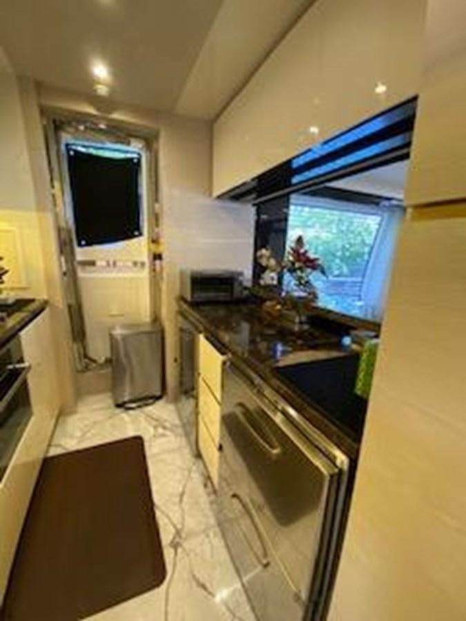 a kitchen with a tv and a stove aboard FORTUNA Yacht for Sale