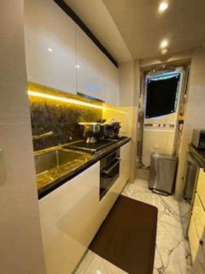 a kitchen with a tv on the wall aboard FORTUNA Yacht for Sale