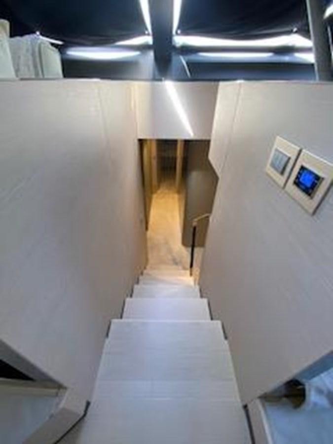 a hallway with a white floor and a white wall with a ceiling and a white rug aboard FORTUNA Yacht for Sale