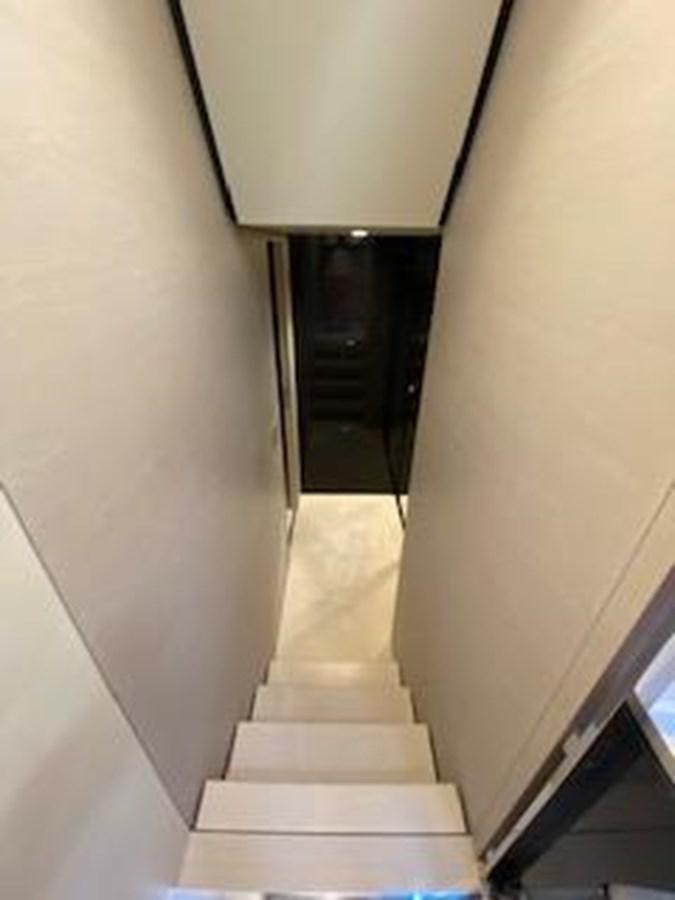 a staircase with a black railing aboard FORTUNA Yacht for Sale