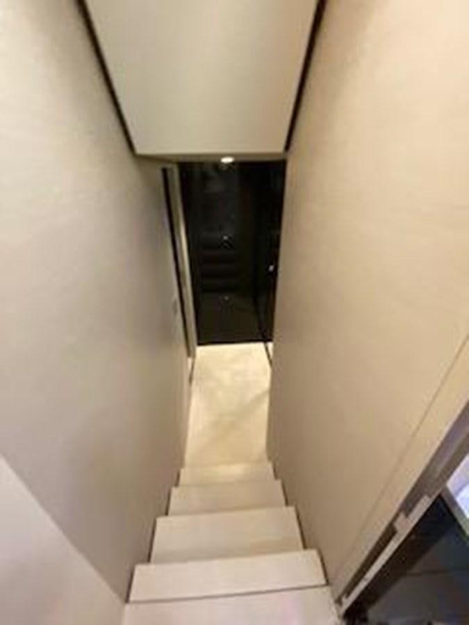 a staircase with a white wall aboard FORTUNA Yacht for Sale