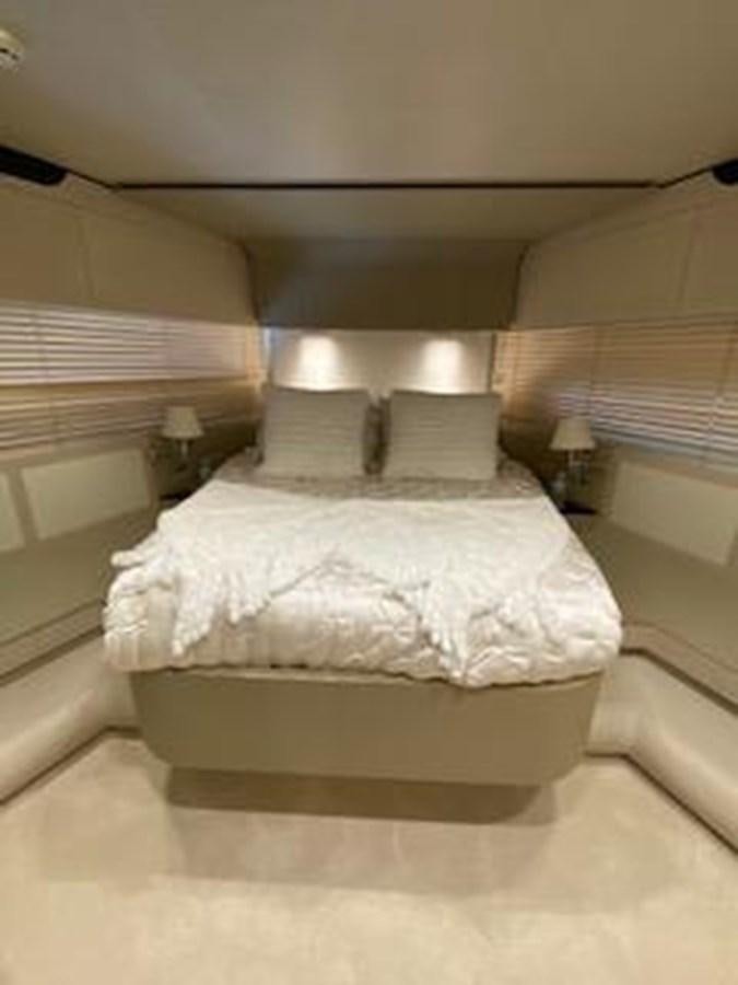 a bed with white sheets aboard FORTUNA Yacht for Sale