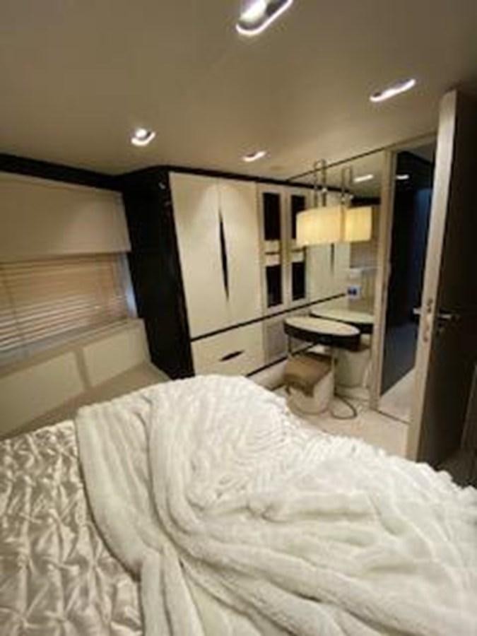 a bedroom with a bed and desk aboard FORTUNA Yacht for Sale