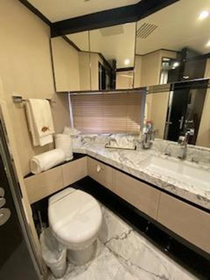 a bathroom with a toilet and a sink aboard FORTUNA Yacht for Sale