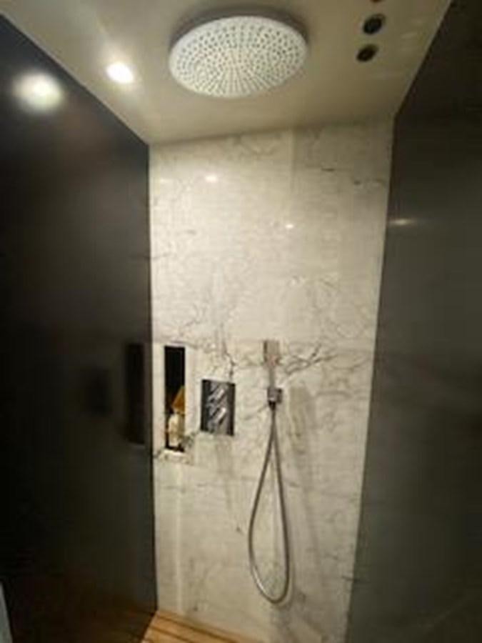 a shower with a sink and a mirror aboard FORTUNA Yacht for Sale