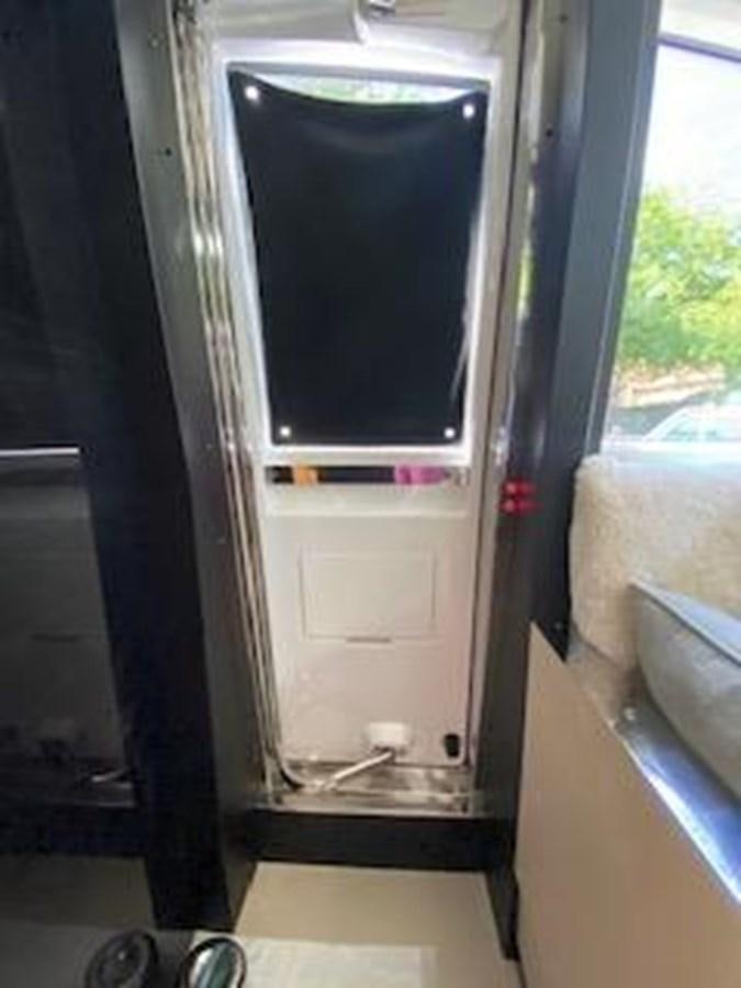 a silver refrigerator in a room aboard FORTUNA Yacht for Sale