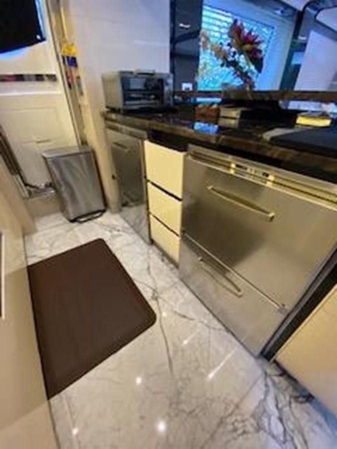 a kitchen with a tv and a rug aboard FORTUNA Yacht for Sale