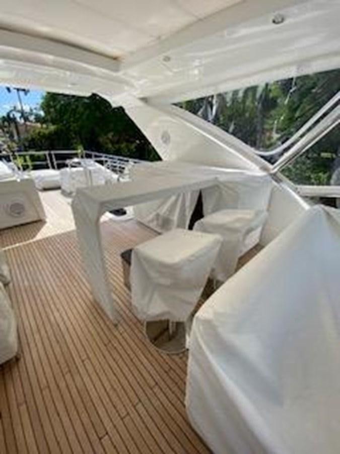 a room with white chairs and a wood floor aboard FORTUNA Yacht for Sale