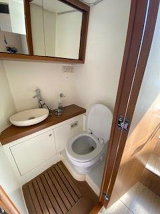 a bathroom with a toilet and a sink aboard FORTUNA Yacht for Sale