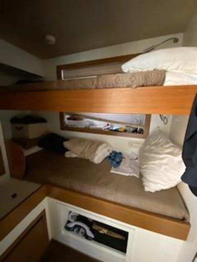 a bed with white sheets aboard FORTUNA Yacht for Sale