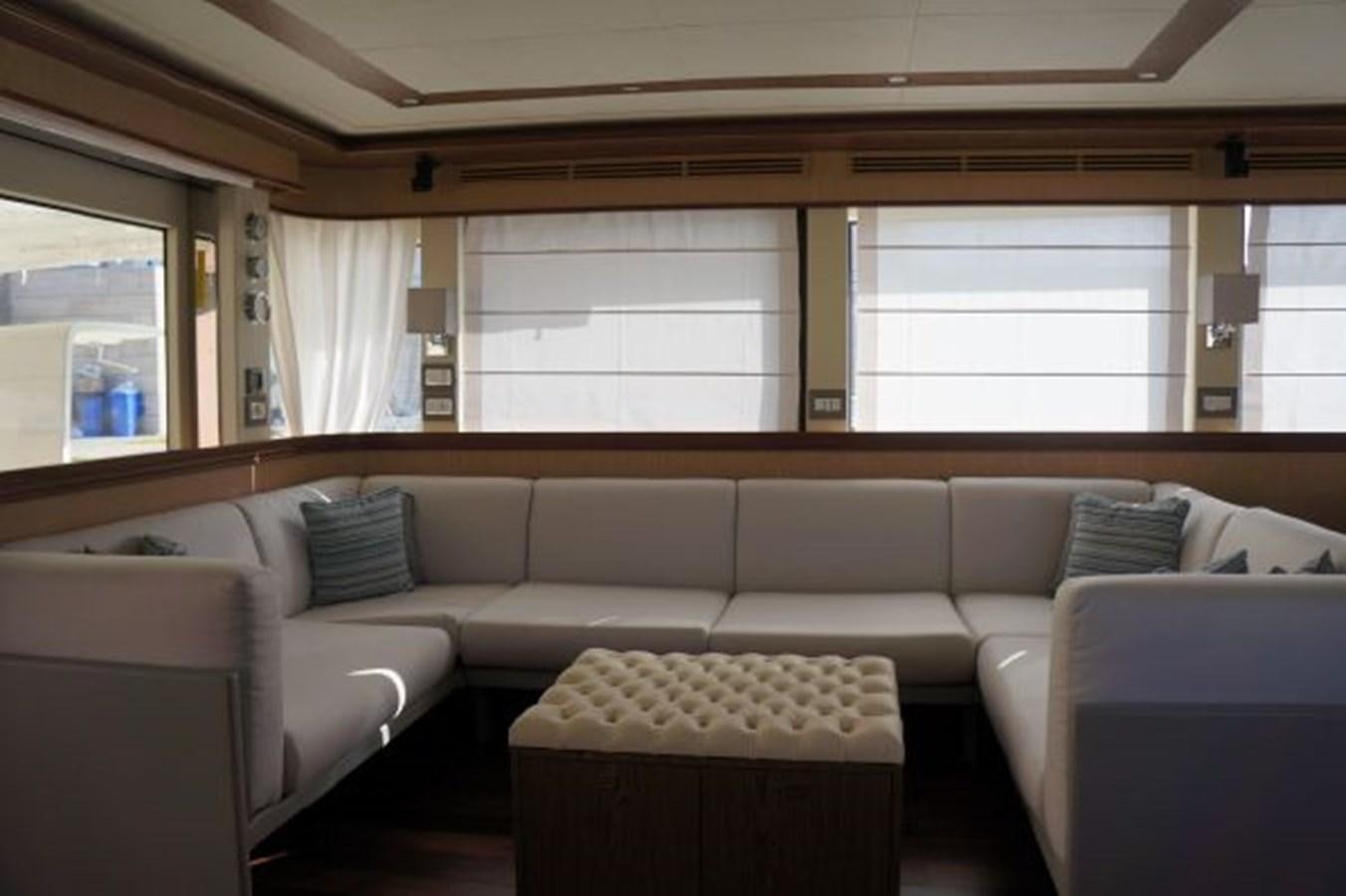 a living room with a couch and a window aboard SANGRIA Yacht for Sale
