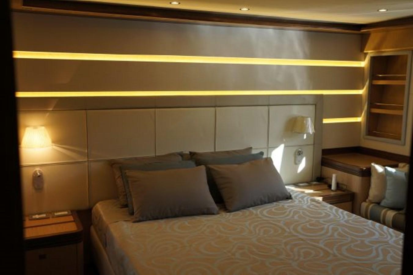 a bed with a white comforter and pillows aboard SANGRIA Yacht for Sale