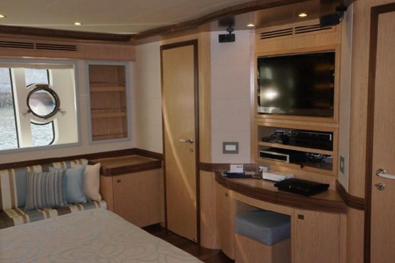 a bedroom with a bed and a television aboard SANGRIA Yacht for Sale