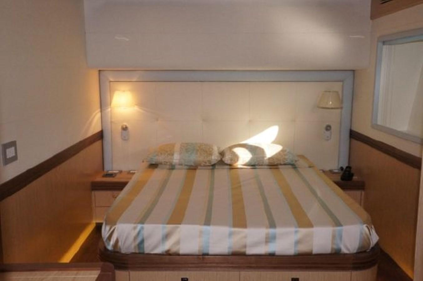 a bed with a striped blanket aboard SANGRIA Yacht for Sale