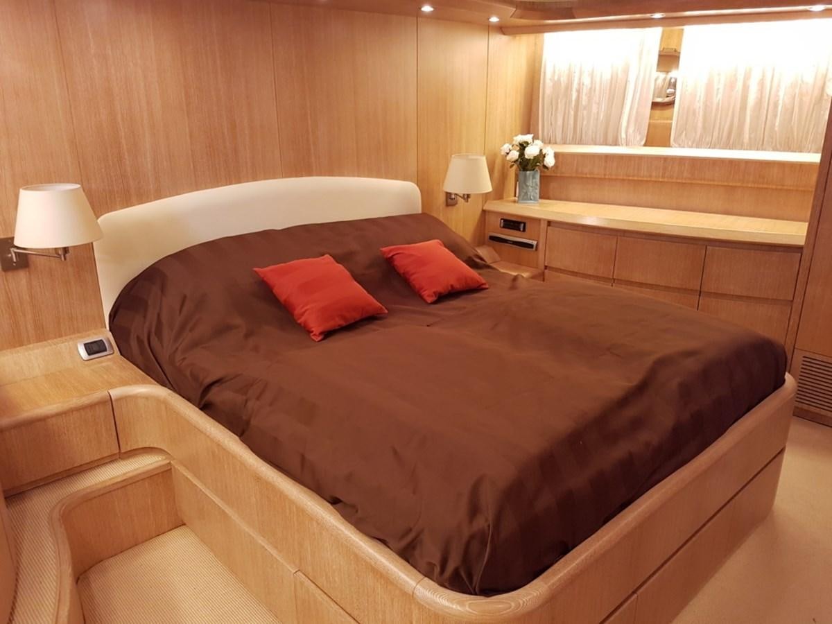 a bed with red pillows aboard COOKIE Yacht for Sale