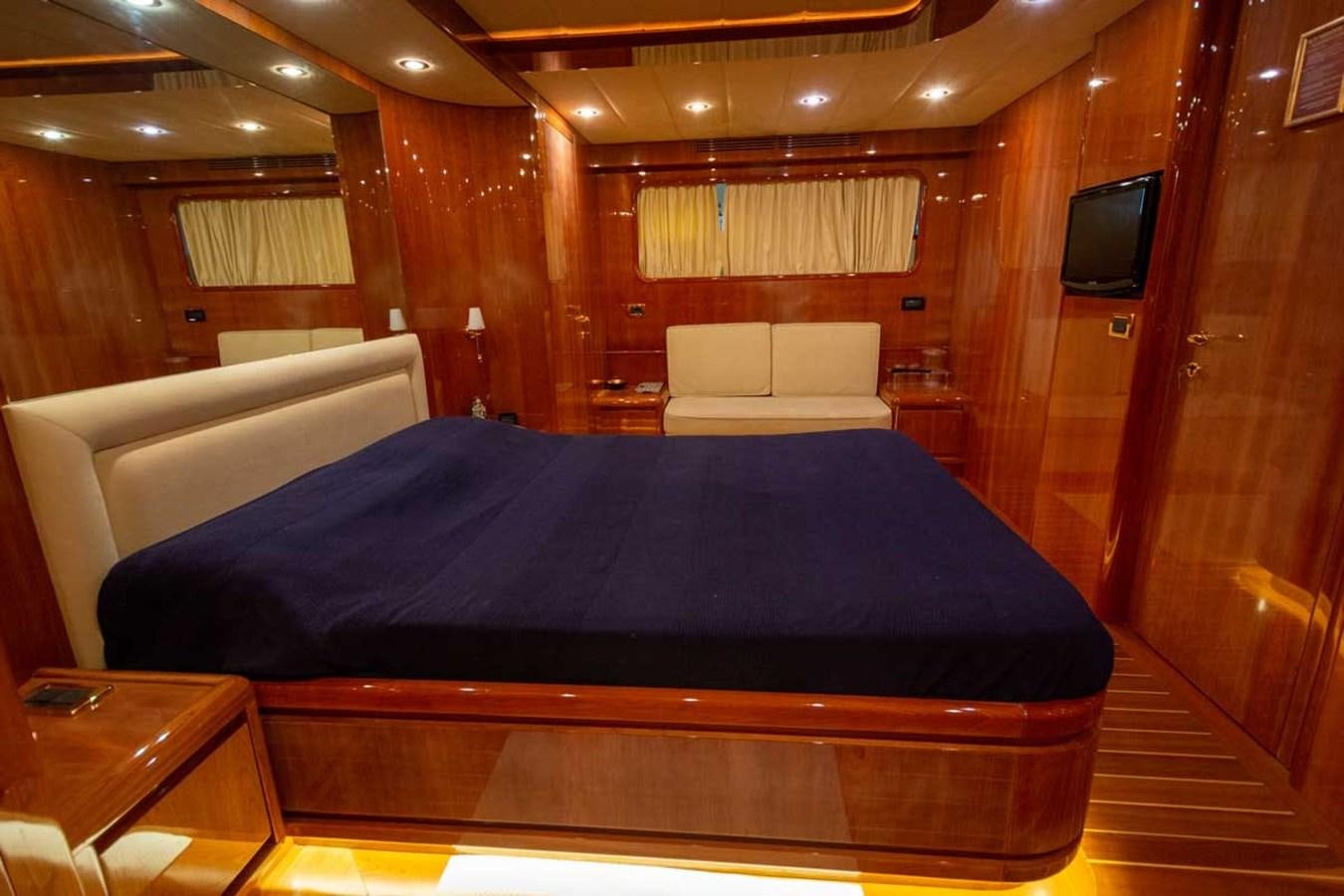 a room with a bed and a tv on the wall aboard ARISTON FIVE Yacht for Sale