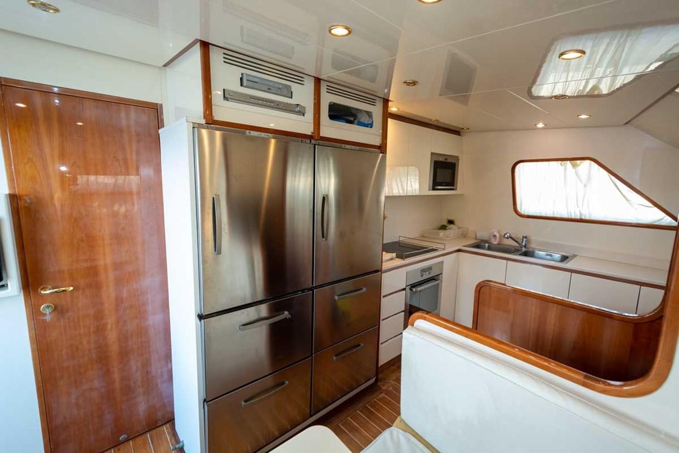 a kitchen with a refrigerator and cabinets aboard ARISTON FIVE Yacht for Sale