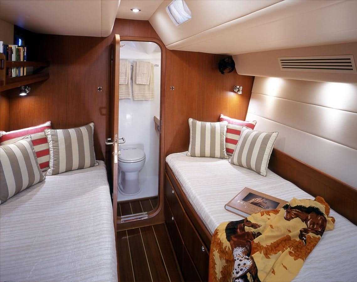a room with a bed and a table aboard OCEAN HORSE Yacht for Sale