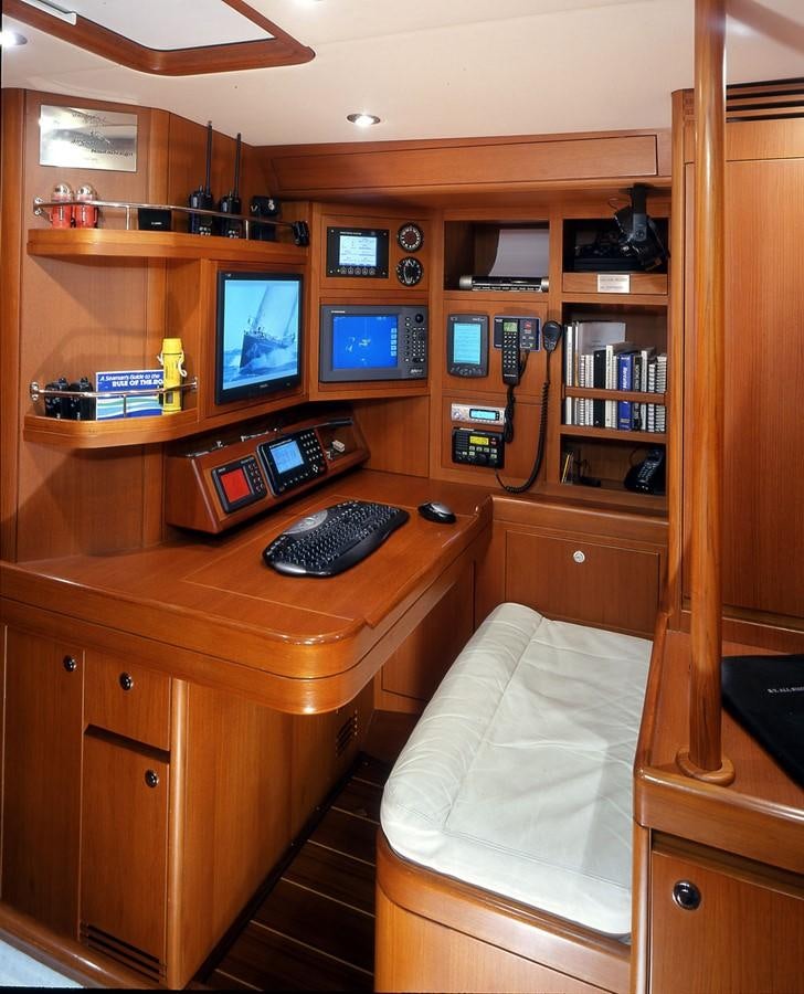 a room with a computer and a bookcase aboard OCEAN HORSE Yacht for Sale