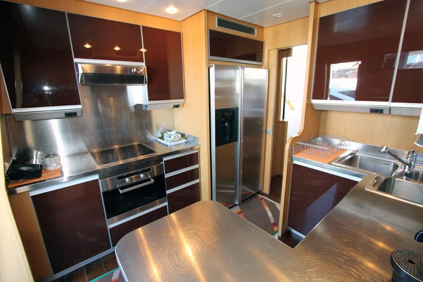 a kitchen with wooden cabinets aboard JAD Yacht for Sale