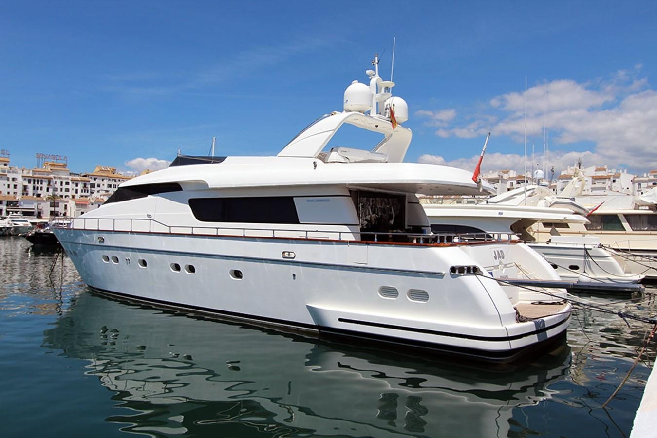 a white yacht in a harbor aboard JAD Yacht for Sale