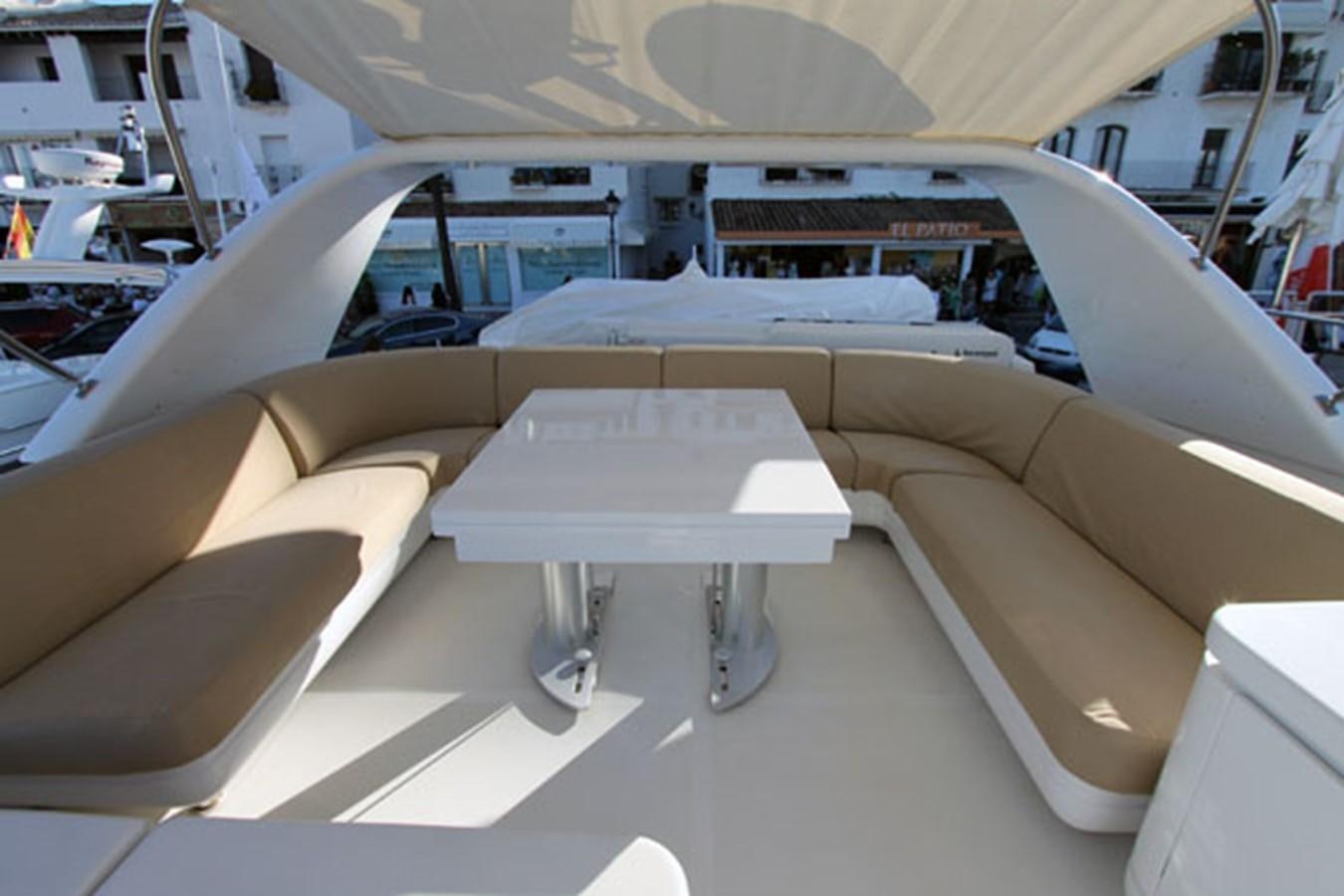a white lounge chair in a room aboard JAD Yacht for Sale