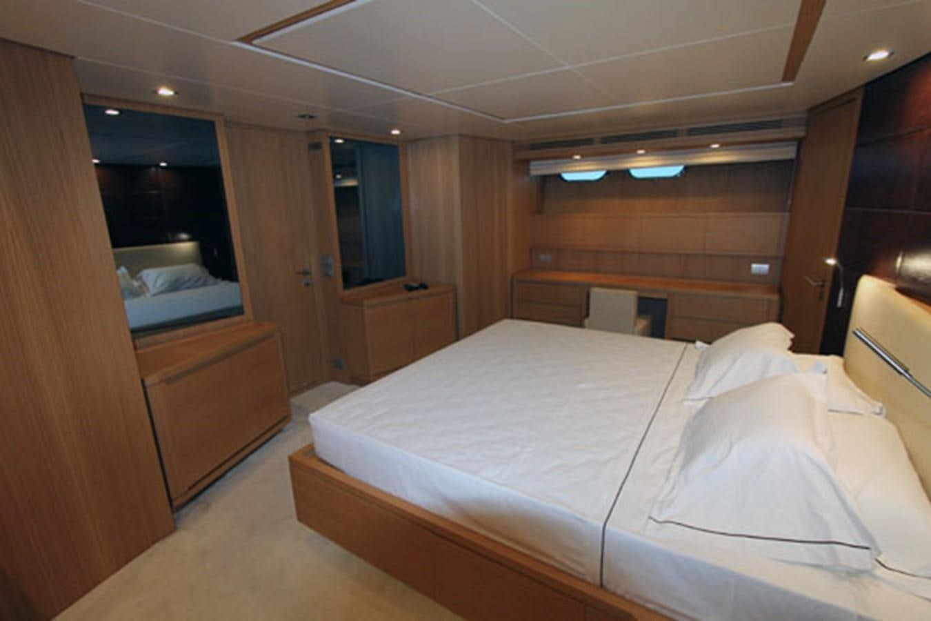 a room with a bed and a desk aboard JAD Yacht for Sale
