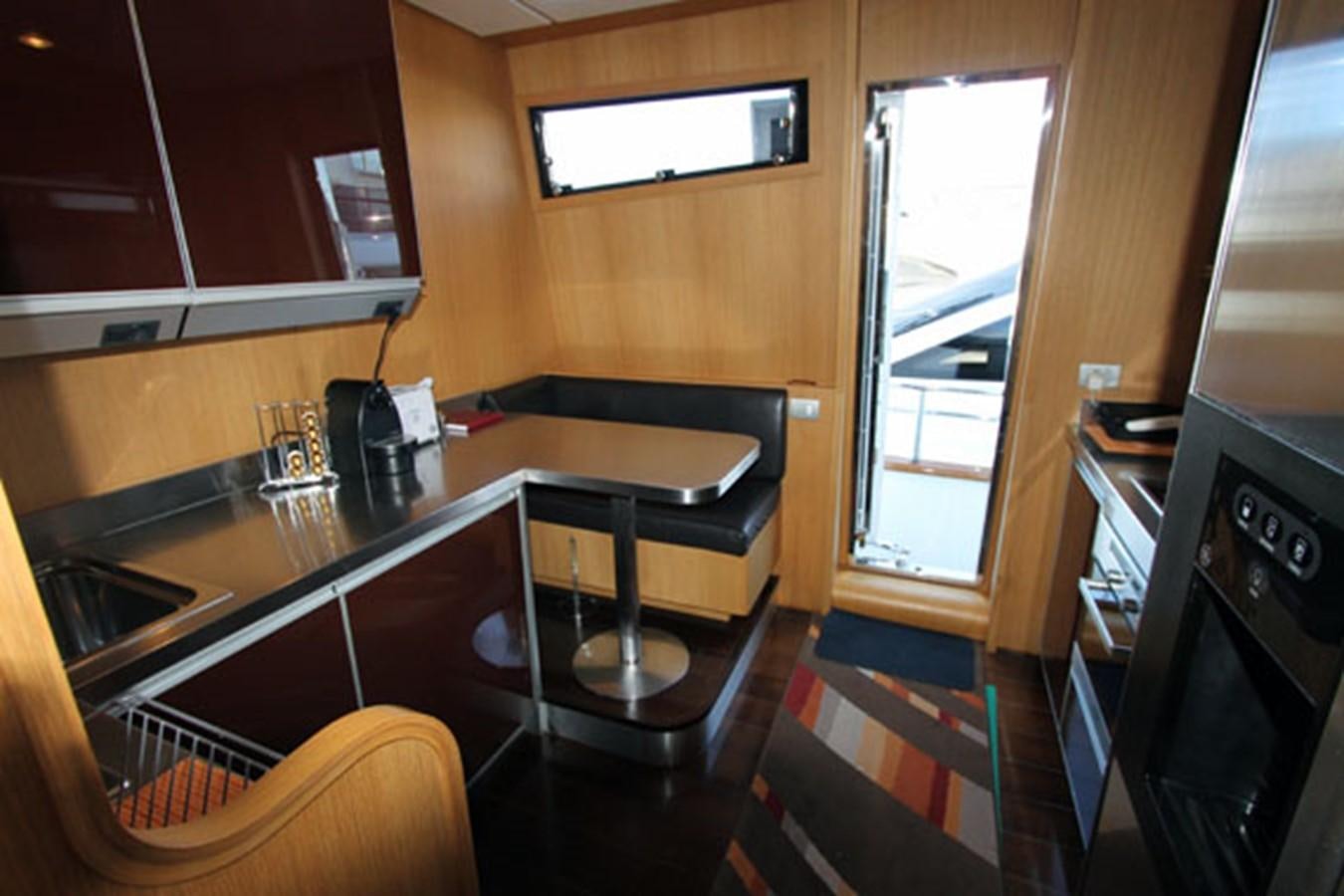 a kitchen with a bar and a table aboard JAD Yacht for Sale
