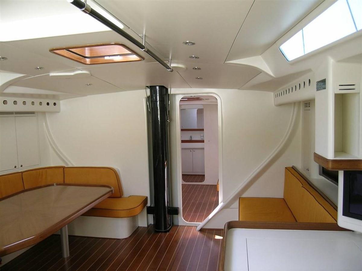 a room with a table and chairs aboard CAPRICORNO Yacht for Sale