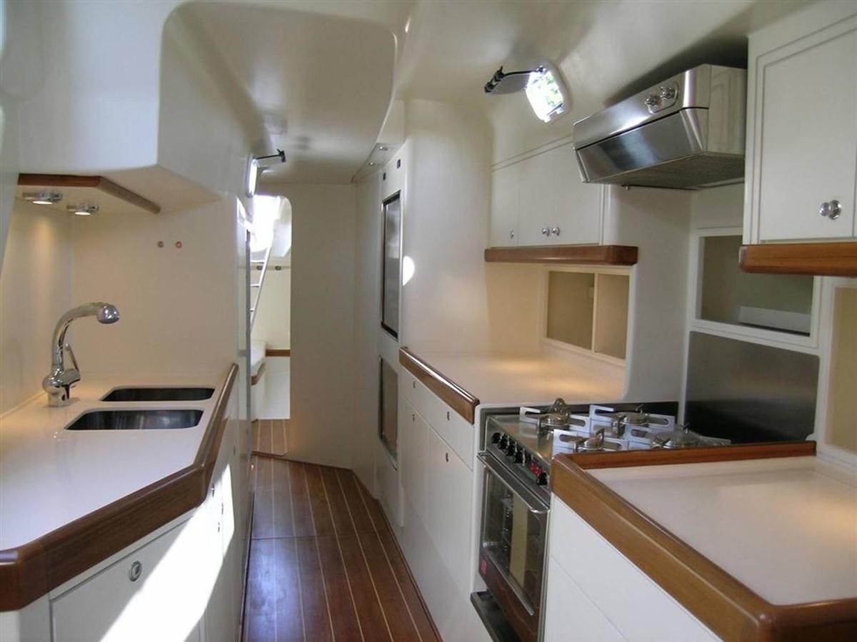 a kitchen with white cabinets aboard CAPRICORNO Yacht for Sale