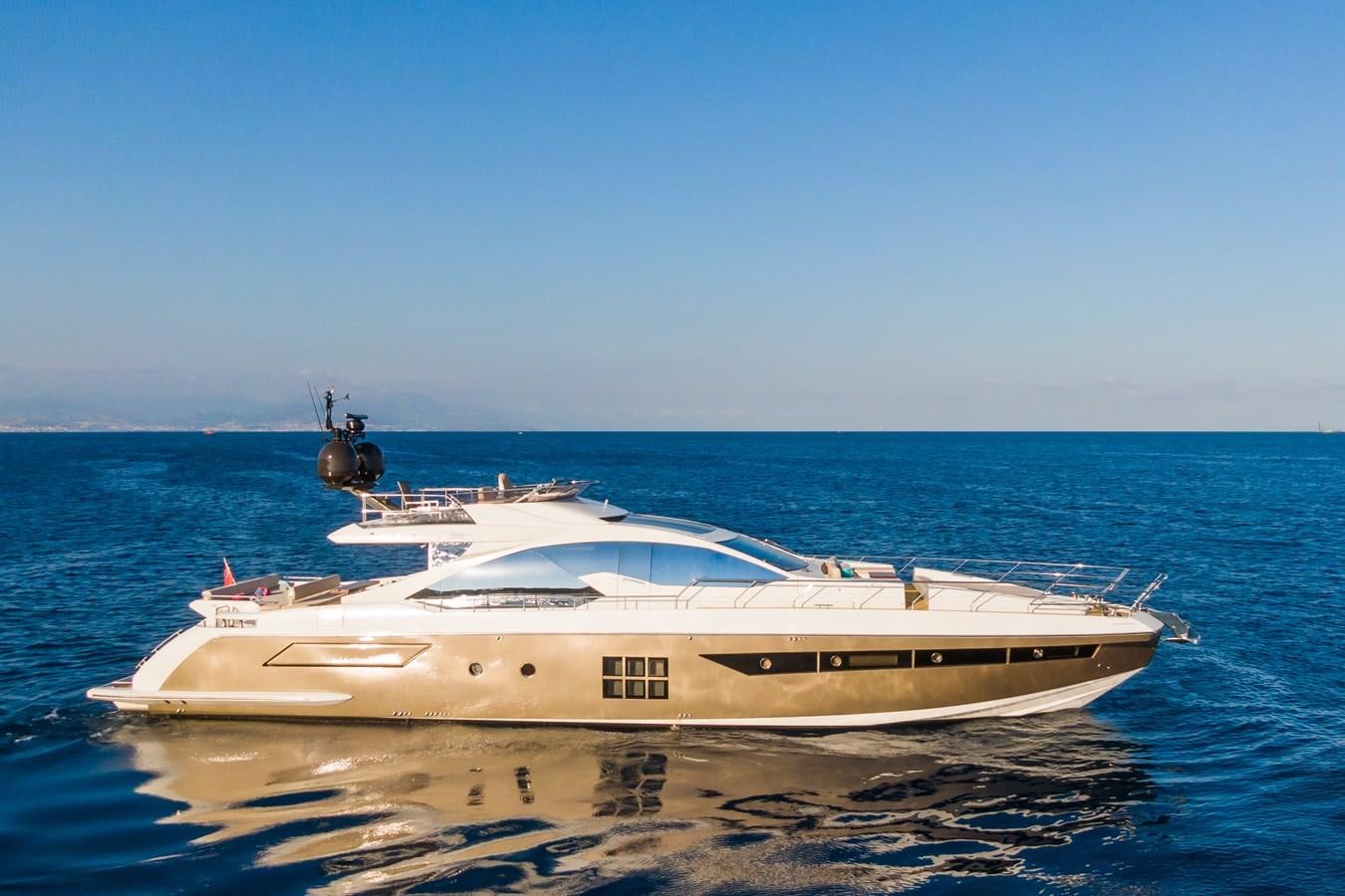 a white boat on the beach aboard YACHTI ANA Yacht for Sale