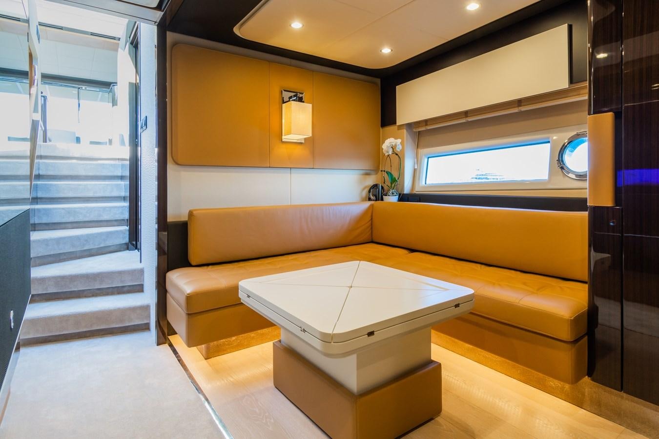 a room with a couch and a staircase aboard YACHTI ANA Yacht for Sale