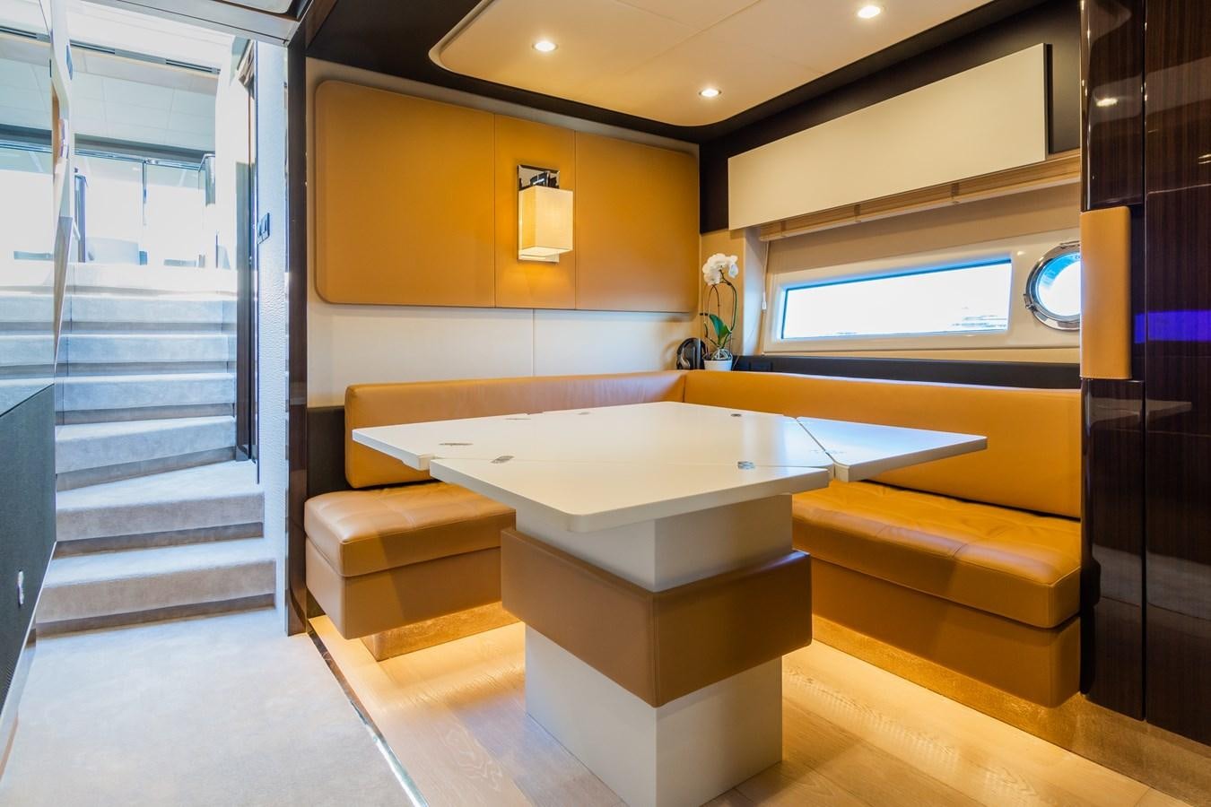 a room with a table and a bench aboard YACHTI ANA Yacht for Sale