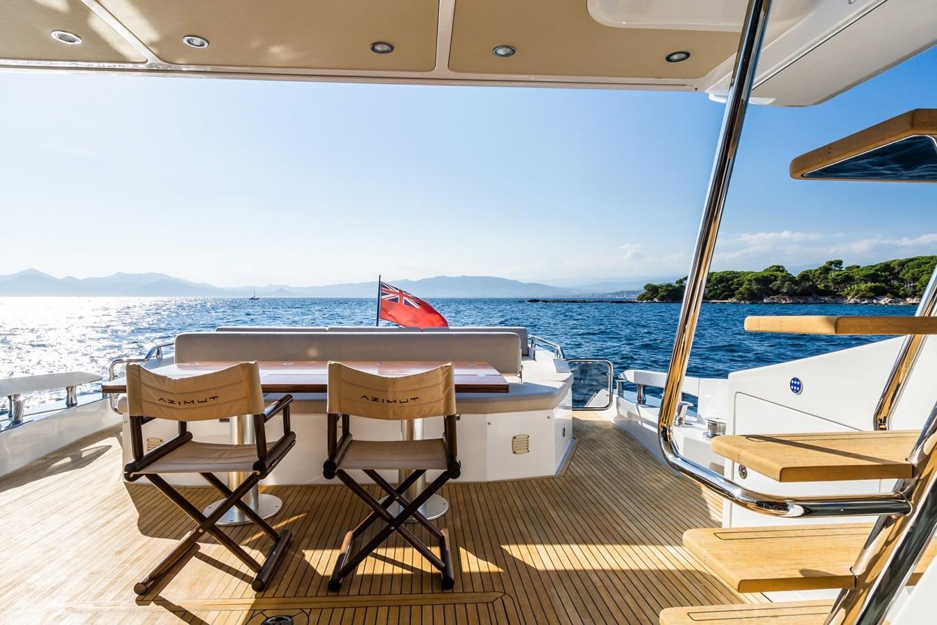 a table and chairs on a deck overlooking a body of water aboard YACHTI ANA Yacht for Sale