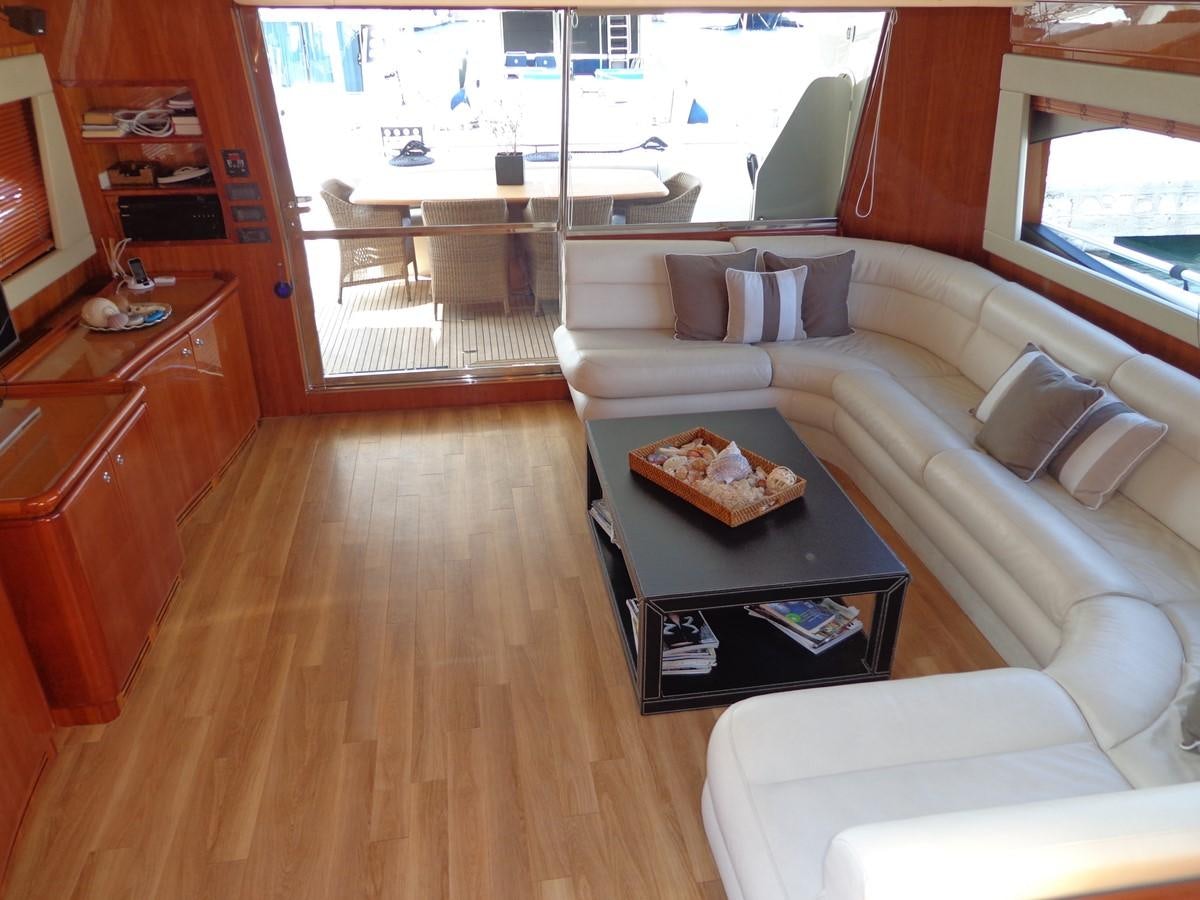 a living room with a large window aboard FERRETTI 760 Yacht for Sale
