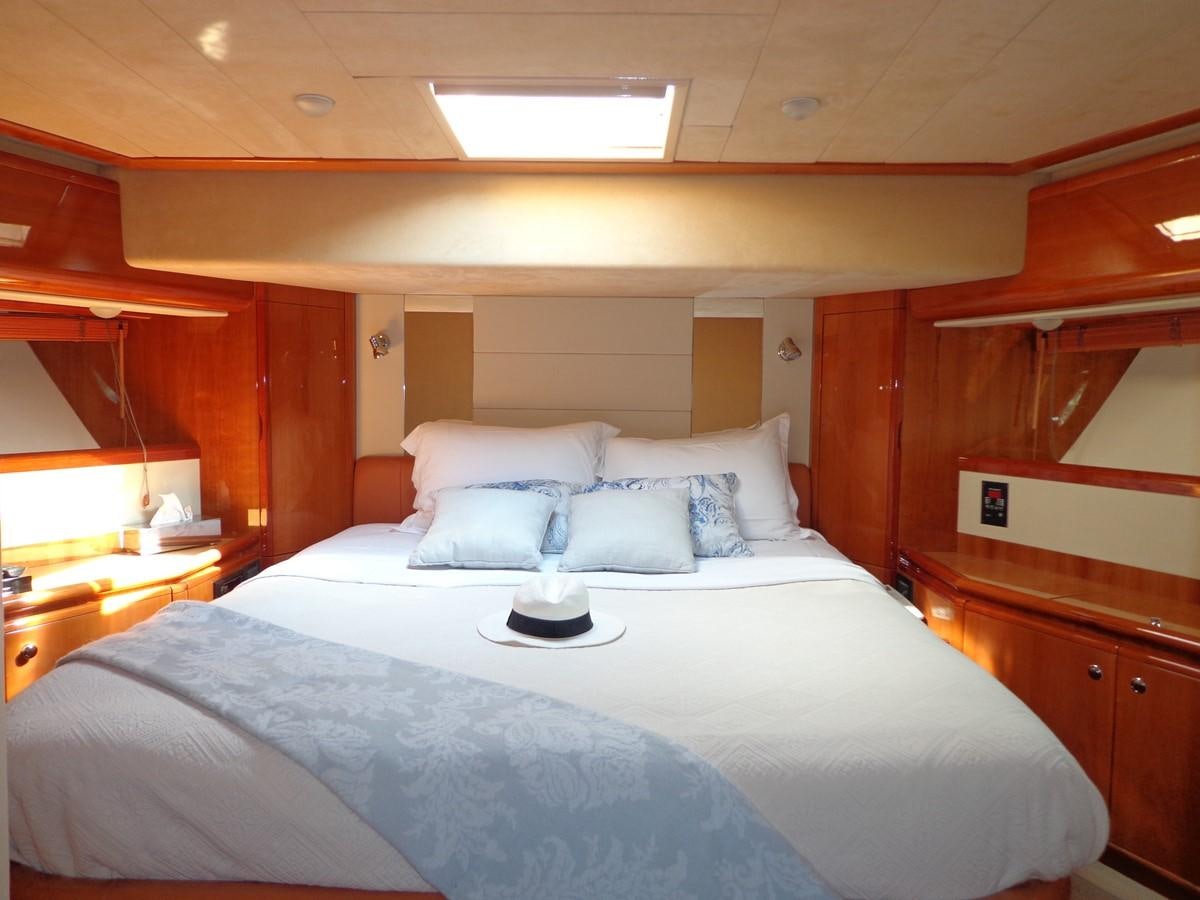 a bed with white sheets aboard FERRETTI 760 Yacht for Sale