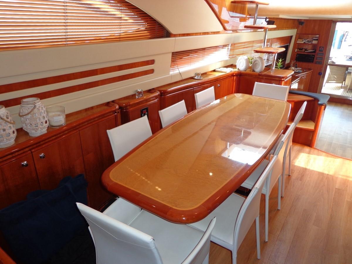 a table with chairs around it aboard FERRETTI 760 Yacht for Sale