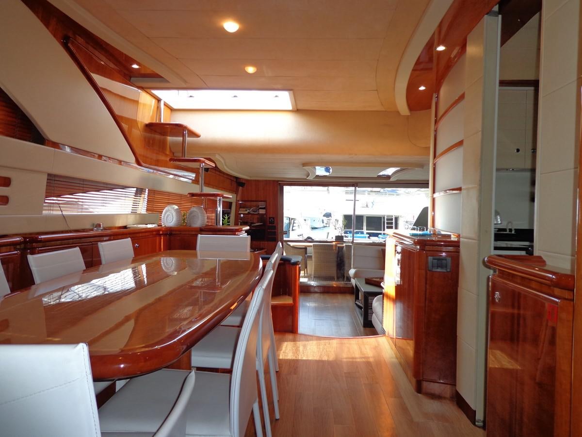 a room with wooden tables and chairs aboard FERRETTI 760 Yacht for Sale