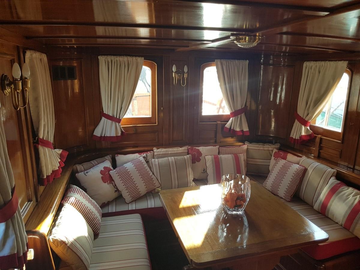 a living room with a large sofa and a table aboard LADY EMMA Yacht for Sale